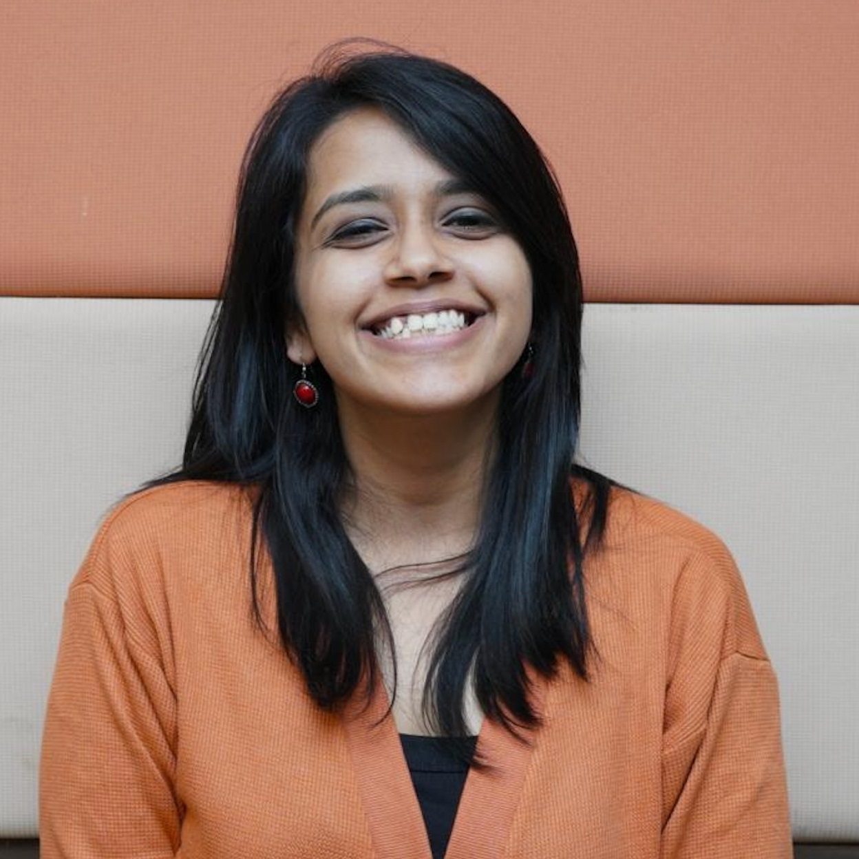 Creative writing objects on a table; pens, pencils, a sketch book, and a cup of coffee.