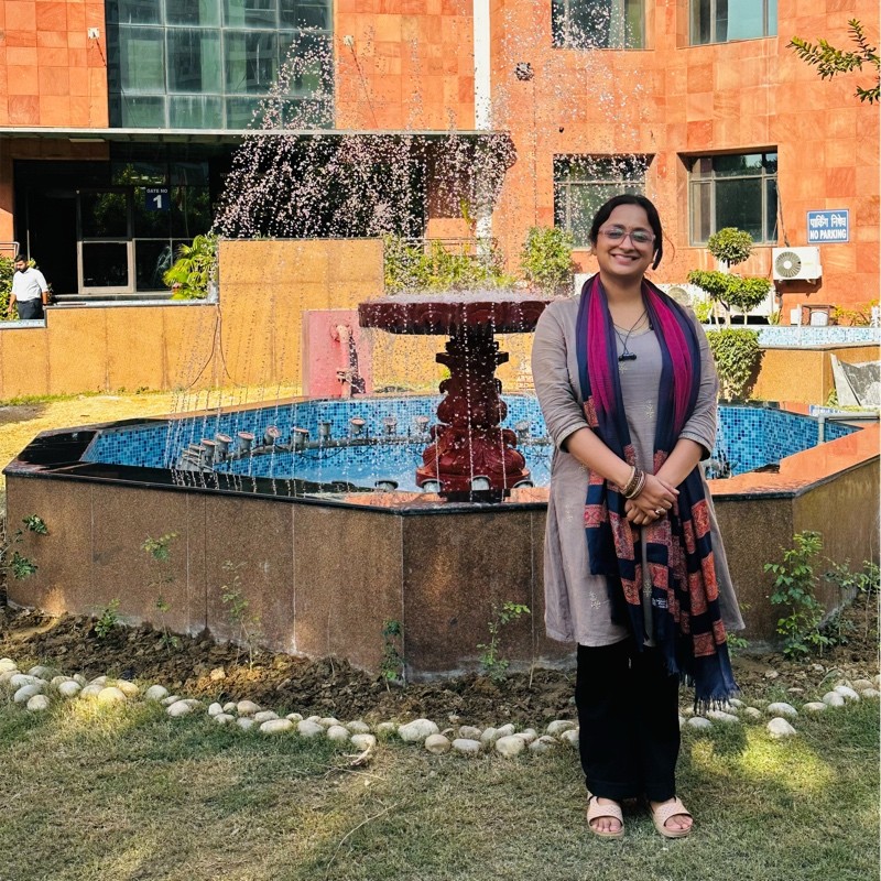 Creative writing objects on a table; pens, pencils, a sketch book, and a cup of coffee.